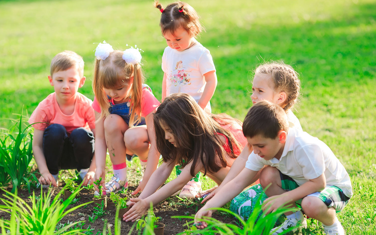 Kids planting in a garden